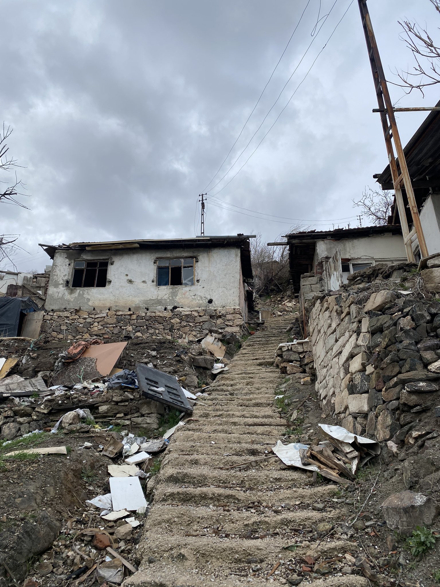 Concrete stairs climbing between crumbling walls in Imrahor