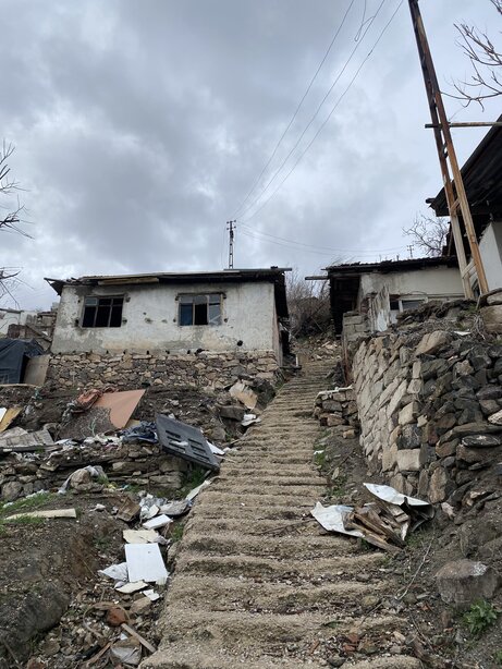 Concrete stairs climbing between crumbling walls in Imrahor