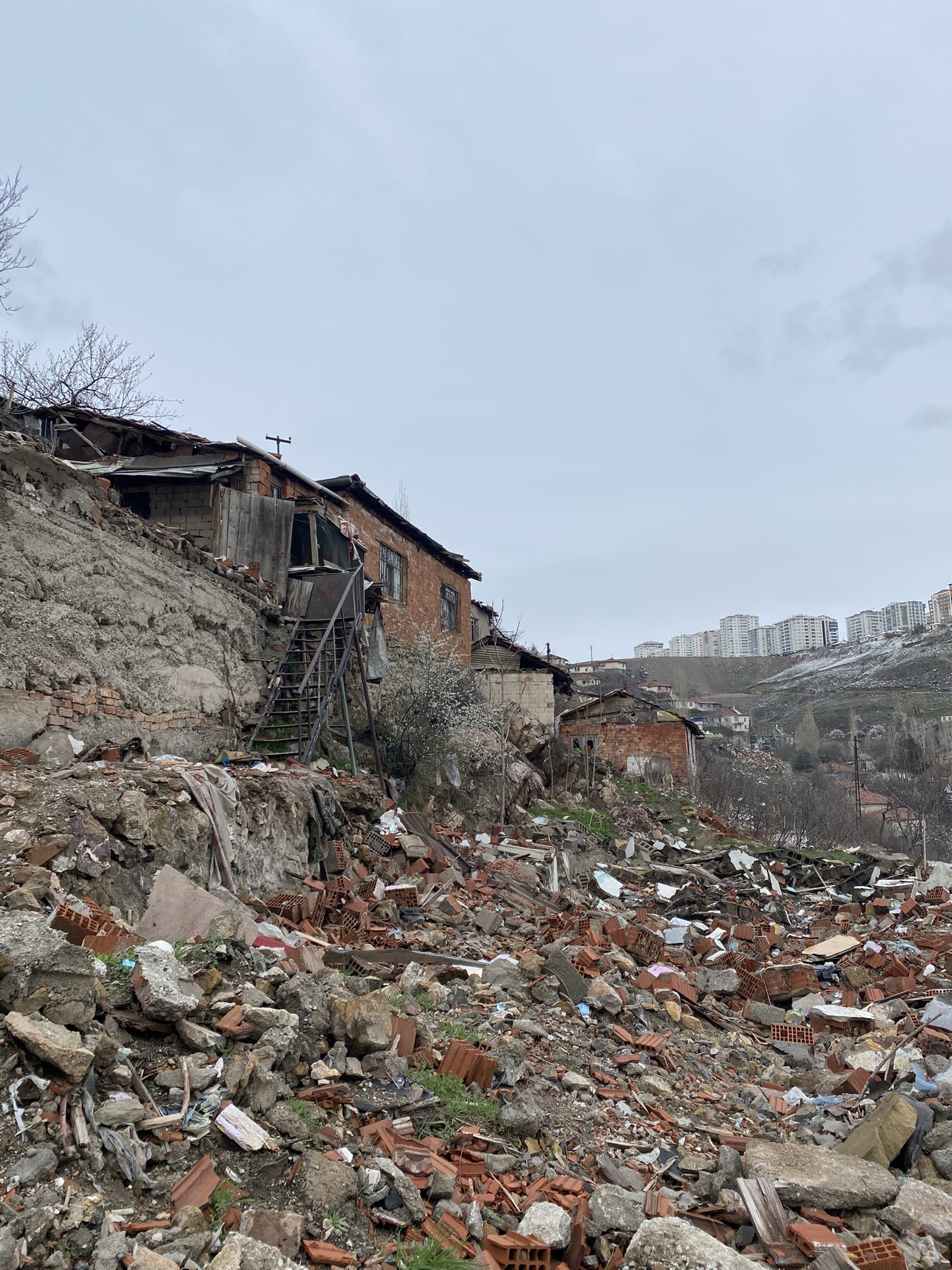 Rubble and remnants along the demolished slope