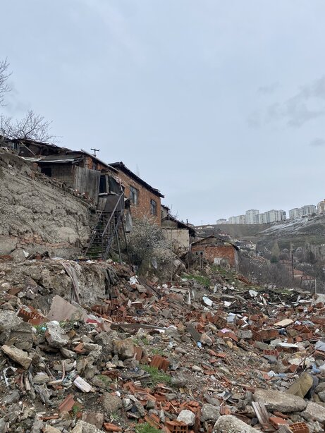 Rubble and remnants along the demolished slope