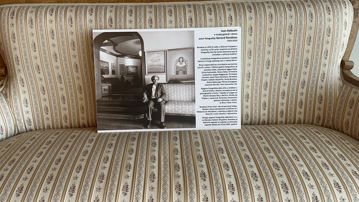 A magazine spread about Ivan Rabuzin on a vintage sofa inside the house